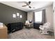 Bedroom featuring neutral walls, work station, crib, rocker and natural lighting at 4227 Diya Ave, North Las Vegas, NV 89084