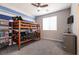 bedroom showcasing bunk beds with a ceiling fan, adjacent to a dresser and TV at 4227 Diya Ave, North Las Vegas, NV 89084