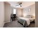 Cozy bedroom with neutral tones, including a workspace, decorated wall art, and natural light through curtains at 4227 Diya Ave, North Las Vegas, NV 89084