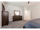 Bright bedroom with a large dresser, open doorway and neutral color palette at 4227 Diya Ave, North Las Vegas, NV 89084