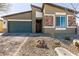 Single-story home with a two car garage, desert landscaping and stone facade at 4227 Diya Ave, North Las Vegas, NV 89084