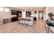 Open kitchen features dark wood cabinets, a large island, and stainless steel appliances at 4227 Diya Ave, North Las Vegas, NV 89084