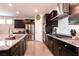 Modern kitchen features stainless steel appliances, granite counters, and dark wood cabinetry at 4227 Diya Ave, North Las Vegas, NV 89084