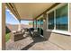 Charming covered patio featuring comfortable seating, a grill, and smooth pavers perfect for outdoor entertaining at 4227 Diya Ave, North Las Vegas, NV 89084