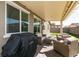 Inviting covered patio with comfortable seating and a grill, extending living space outdoors for relaxation and gatherings at 4227 Diya Ave, North Las Vegas, NV 89084
