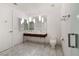 Well-lit bathroom features dual sinks, floating vanity, marble floors, and glass shower door at 4471 Dean Martin Dr # 1207, Las Vegas, NV 89103