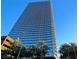 Tall, modern high-rise features sleek architectural design, balconies, and ample windows, surrounded by lush palm trees at 4471 Dean Martin Dr # 1207, Las Vegas, NV 89103