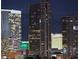 Nighttime cityscape view featuring multiple high-rise buildings with illuminated windows and stunning architectural designs at 4471 Dean Martin Dr # 1207, Las Vegas, NV 89103
