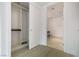 Walk-in closet featuring custom shelving and rods, leading to a bathroom with marble flooring at 4471 Dean Martin Dr # 1207, Las Vegas, NV 89103