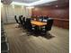 Modern conference room with sleek chairs and large wooden table, featuring ample seating and neutral color scheme at 4471 Dean Martin Dr # 1207, Las Vegas, NV 89103