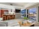 Open living area with modern kitchen, bar seating, and expansive city views through large windows at 4471 Dean Martin Dr # 1207, Las Vegas, NV 89103