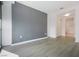 Bright, spacious living room features contemporary design with gray accent wall and wood flooring at 4471 Dean Martin Dr # 1207, Las Vegas, NV 89103