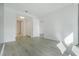 Sunlit, open-concept living space with white walls, light wood floors, and access to a hallway at 4471 Dean Martin Dr # 1207, Las Vegas, NV 89103