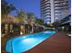 Inviting pool at dusk, lined with luxurious cabanas and lush landscaping at 4471 Dean Martin Dr # 1207, Las Vegas, NV 89103