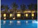 Inviting pool featuring illuminated cabanas and tranquil water at 4471 Dean Martin Dr # 1207, Las Vegas, NV 89103