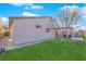 Well-maintained backyard with a lush green lawn, mature landscaping, and partial fencing at 4655 Fire Fly Cir, Las Vegas, NV 89122