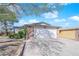 Home featuring a two-car garage, driveway, and desert landscaping at 4655 Fire Fly Cir, Las Vegas, NV 89122