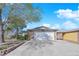 Charming front exterior of a home featuring a two-car garage, stone accents, and a well-maintained lawn at 4655 Fire Fly Cir, Las Vegas, NV 89122