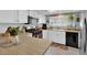 Bright kitchen featuring white cabinetry, wood countertops, and black appliances at 4655 Fire Fly Cir, Las Vegas, NV 89122
