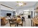 Open floor plan with a dining table near a living room with lots of natural light and a stove at 4655 Fire Fly Cir, Las Vegas, NV 89122