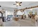 Bright living room with comfortable seating, a wood burning stove, and sliding glass doors that lead to the patio at 4655 Fire Fly Cir, Las Vegas, NV 89122