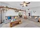 Open living room area with comfortable couches, decor shelves, and an adjacent dining area at 4655 Fire Fly Cir, Las Vegas, NV 89122