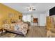 Comfortable main bedroom featuring a decorative bedspread, wood floors, and warm lighting at 4655 Fire Fly Cir, Las Vegas, NV 89122