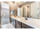 Bathroom features a double sink vanity and mirrors with doorways to other rooms at 5027 Crown Cypress St, Las Vegas, NV 89149