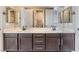 Bathroom features a double sink vanity and mirrors with updated black faucets at 5027 Crown Cypress St, Las Vegas, NV 89149