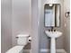 Cozy half-bathroom featuring a sleek pedestal sink and modern fixtures at 5027 Crown Cypress St, Las Vegas, NV 89149
