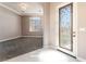 Bright foyer featuring decorative glass door, elegant tile flooring, and an open view to a carpeted living space at 5027 Crown Cypress St, Las Vegas, NV 89149