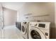 Bright laundry room featuring modern washer and dryer units and counter space at 5027 Crown Cypress St, Las Vegas, NV 89149