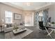 Comfortable living room with stylish decor, including a plush sofa, modern coffee table, and elegant patterned curtains at 5027 Crown Cypress St, Las Vegas, NV 89149