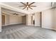 Expansive living room offering tray ceilings, a ceiling fan, and access to the outdoors at 5027 Crown Cypress St, Las Vegas, NV 89149