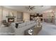 Open-concept living area with a modern fireplace, stylish furniture, and seamless connection to the kitchen at 5027 Crown Cypress St, Las Vegas, NV 89149