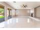 Large living area with tile floors, ceiling fan, fireplace, and sliding glass doors to outdoor patio at 5027 Crown Cypress St, Las Vegas, NV 89149