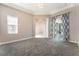 Spacious living room features modern decor, an open layout, with neutral walls and carpeted flooring at 5027 Crown Cypress St, Las Vegas, NV 89149