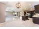 Open-concept living space with modern lighting, tiled floors, and a cozy fireplace at 5027 Crown Cypress St, Las Vegas, NV 89149