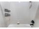 Clean, bright white-tiled shower with convenient shelving for bath products at 5027 Crown Cypress St, Las Vegas, NV 89149