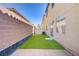 Artificial grass and a secure fence define the outdoor area, creating a private and serene atmosphere at 5948 Sakhalin Ave, Las Vegas, NV 89139