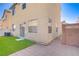 View of backyard with artificial grass, patio, air conditioner and partially fenced-in perimeter at 5948 Sakhalin Ave, Las Vegas, NV 89139