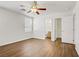 Unfurnished bedroom features a ceiling fan, wood floors, and neutral walls at 5948 Sakhalin Ave, Las Vegas, NV 89139