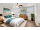 Bright bedroom featuring a ceiling fan, wood floors, and neutral walls at 5948 Sakhalin Ave, Las Vegas, NV 89139