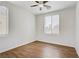 Bedroom with neutral walls, wood floor and two windows at 5948 Sakhalin Ave, Las Vegas, NV 89139
