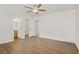 Unfurnished bedroom features a ceiling fan, wood floors, and neutral walls at 5948 Sakhalin Ave, Las Vegas, NV 89139