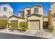 Charming two-story home with a welcoming facade, dual car garage, and well-maintained landscaping at 5948 Sakhalin Ave, Las Vegas, NV 89139