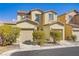 Inviting two-story home with a charming facade, dual car garage, and well-maintained landscaping at 5948 Sakhalin Ave, Las Vegas, NV 89139