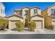 Inviting two-story home with a charming facade, dual car garage, and well-maintained landscaping at 5948 Sakhalin Ave, Las Vegas, NV 89139