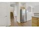 Bright kitchen area featuring stainless steel appliances, and access to upstairs at 5948 Sakhalin Ave, Las Vegas, NV 89139