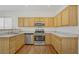 Well-equipped kitchen with stainless steel appliances, and light wooden cabinets at 5948 Sakhalin Ave, Las Vegas, NV 89139